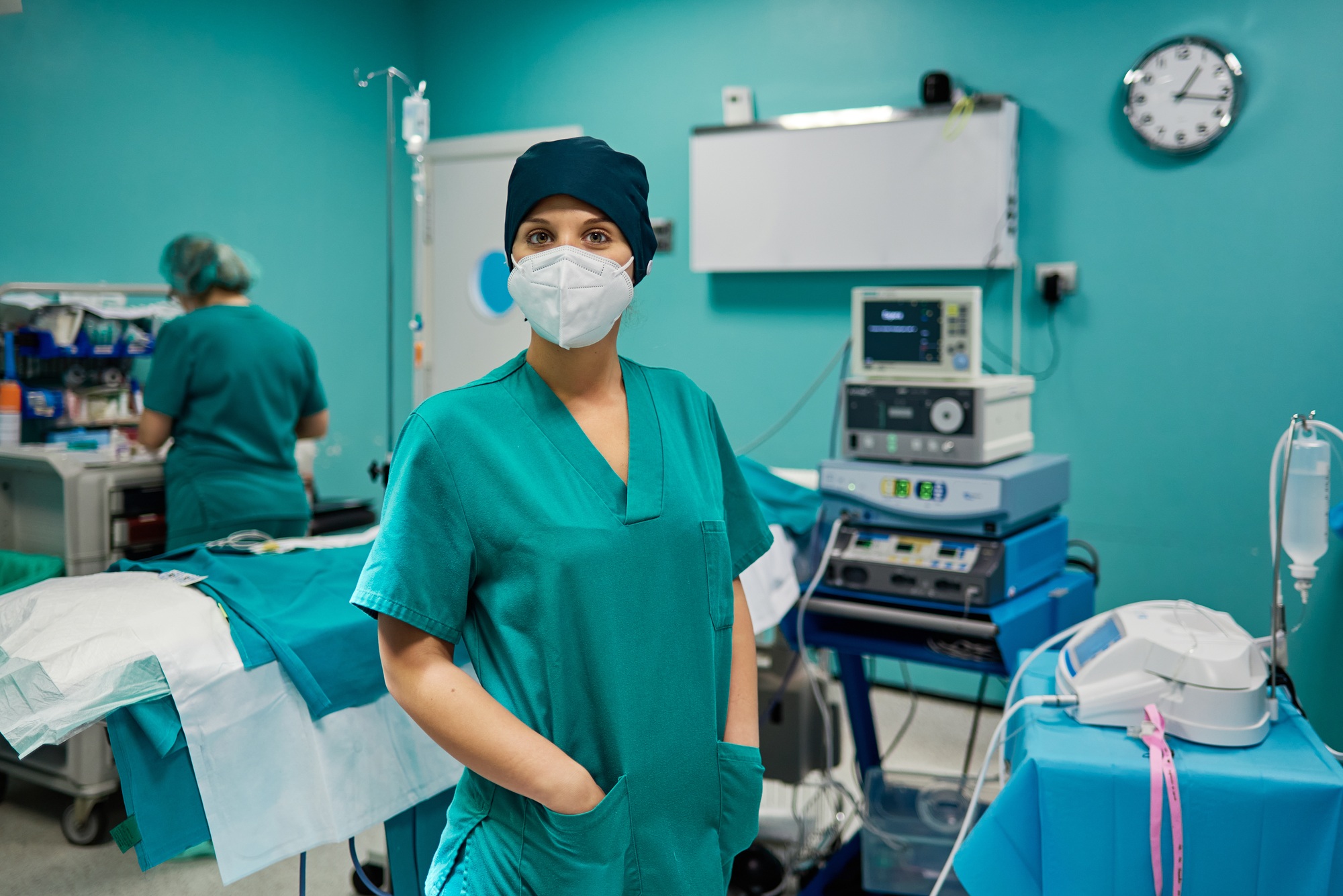 Surgeon in uniform and respiratory mask in clinic